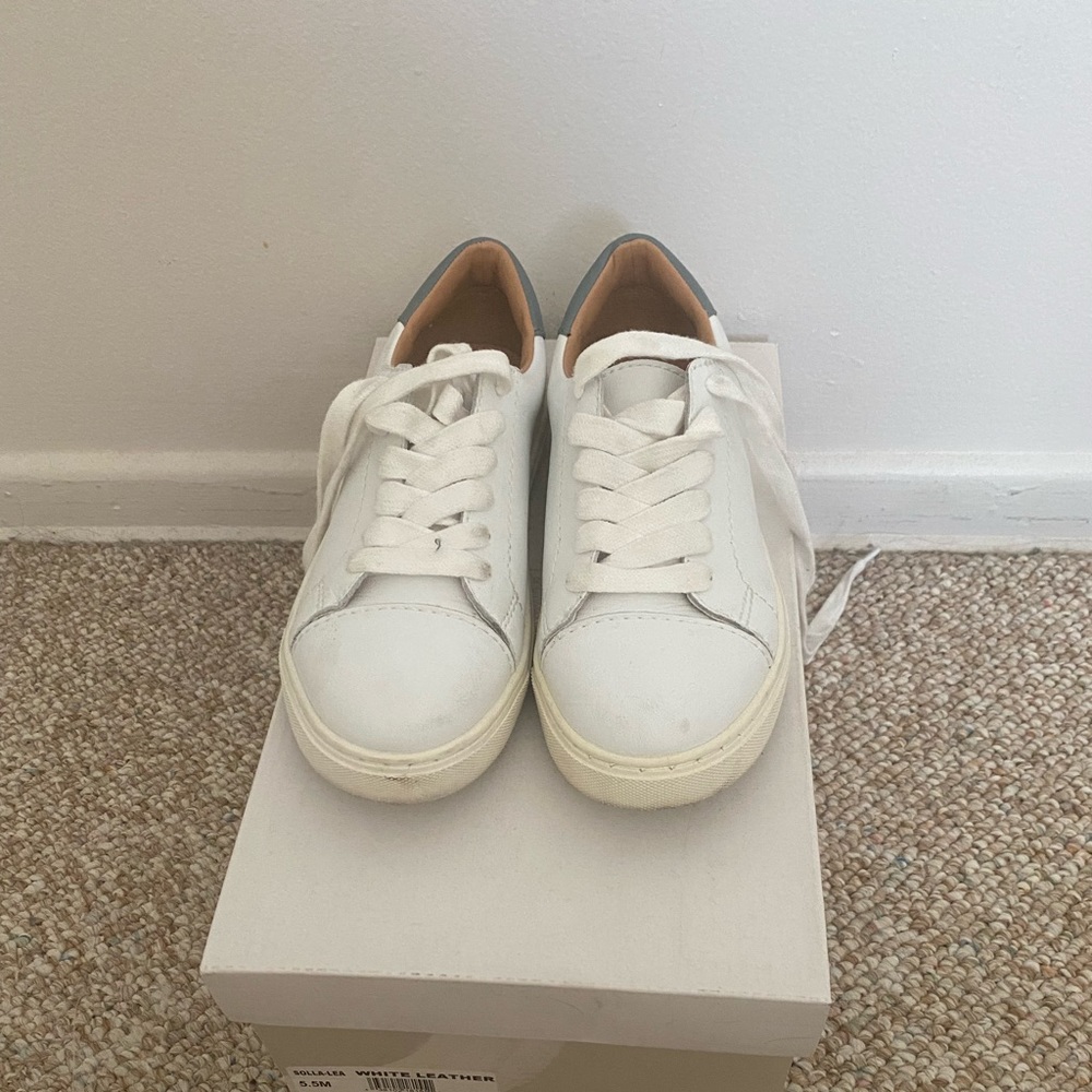 white 14th and Union sneakers.